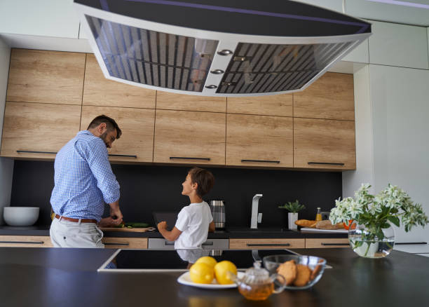 istock Happy father and son cooking together in the kitchen 1193907298