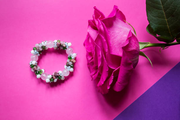 wreath of beautiful fresh rose flowers and green leaves on a white background. holiday layout. flat lay, place for text.