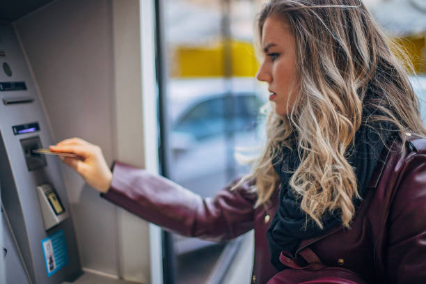 istock Woman is withdrawing money from ATM machine 1193910176