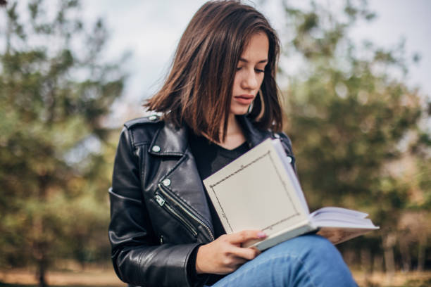 istock Young woman is reading a book 1193911686