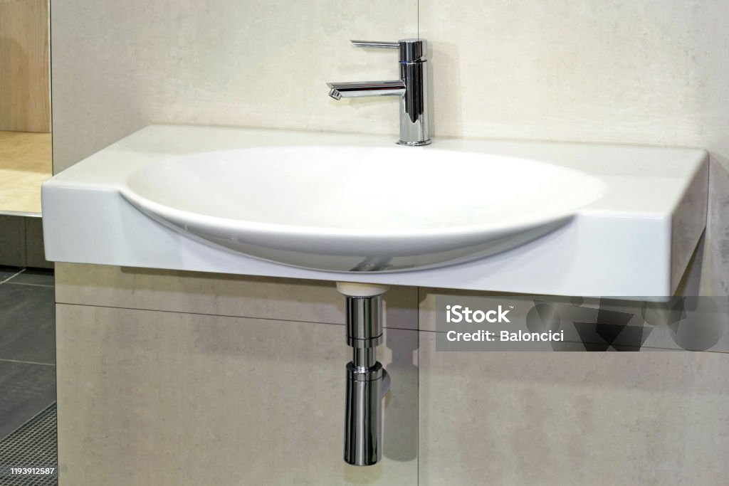 Wide basin Simple white basin in wide oval shape Architecture Stock Photo