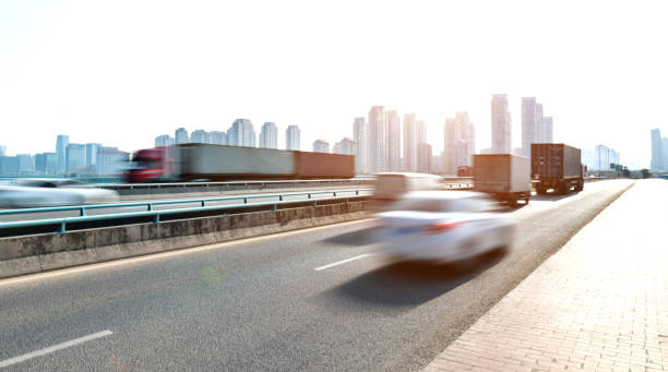 istock Trucks and car speeding on city viaduct 1193912828