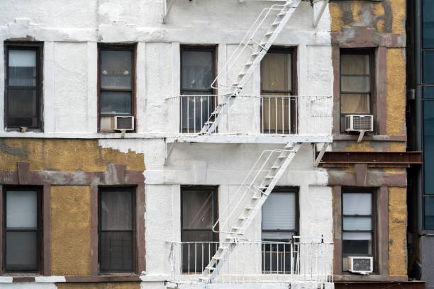 istock Half-painted New York Building with Fire Escapes 1193915052