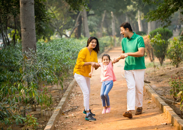 istock Happy family playing at park 1193915681
