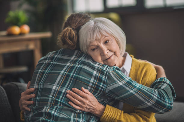 istock Grey-haired elderly lady looking happy with her son 1193919146