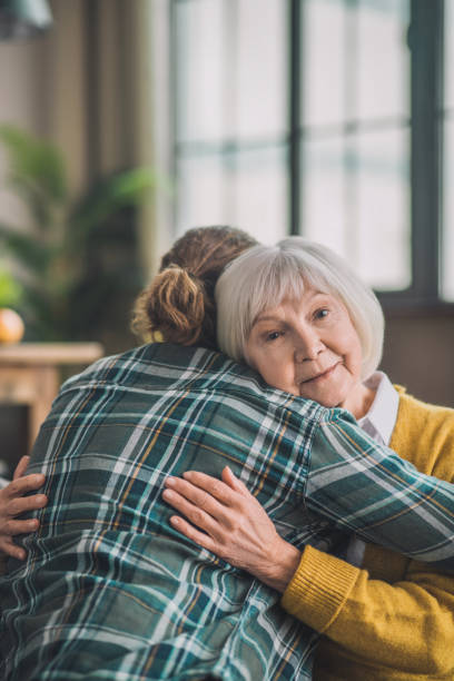istock Grey-haired elderly lady feeling happy with her son 1193919154