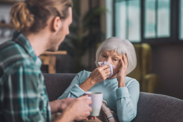 istock Old grey-haired lady suffering from strong headache 1193919869