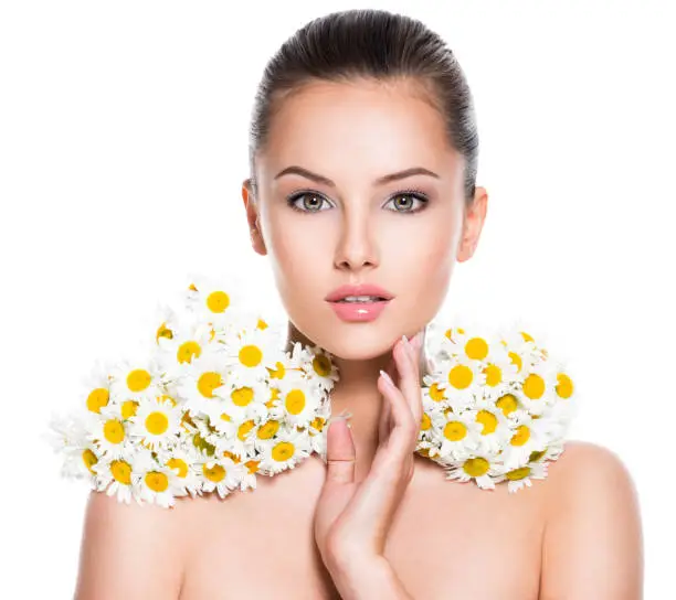 Photo of Face of young beautiful woman with posy flowers