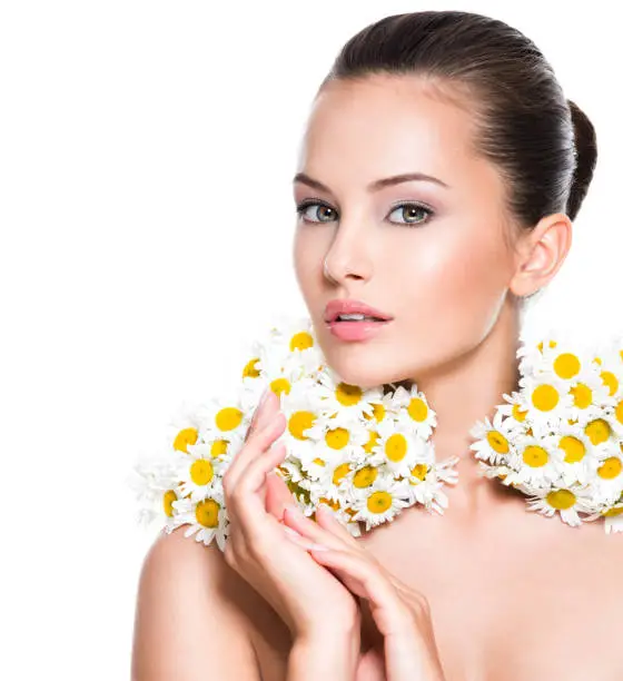 Photo of Face of young beautiful woman with posy flowers