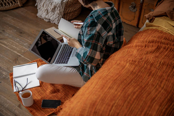 istock Young lady woring with laptop in bedroom 1193923436