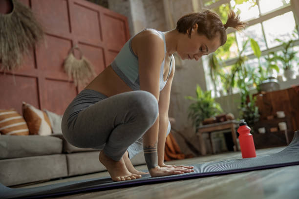 istock Young pretty lady is practicing meditation indoors 1193923734