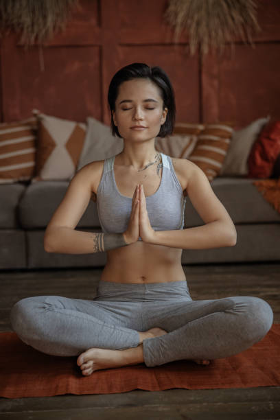 istock Meditating girl is practicing yoga at home 1193923806