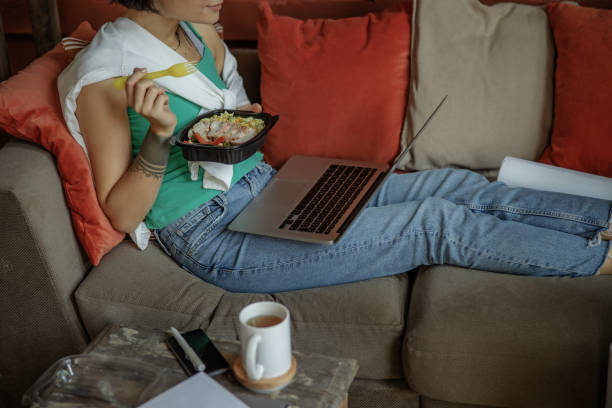 istock Lady is sitting with laptop on sofa 1193923861
