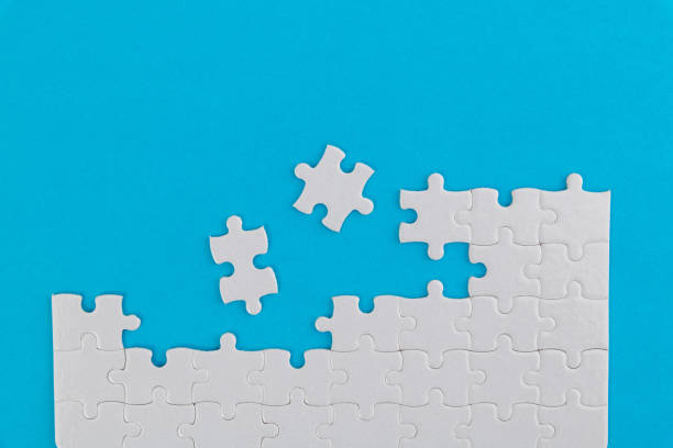 istock White jigsaw puzzle on blue background 1193925358