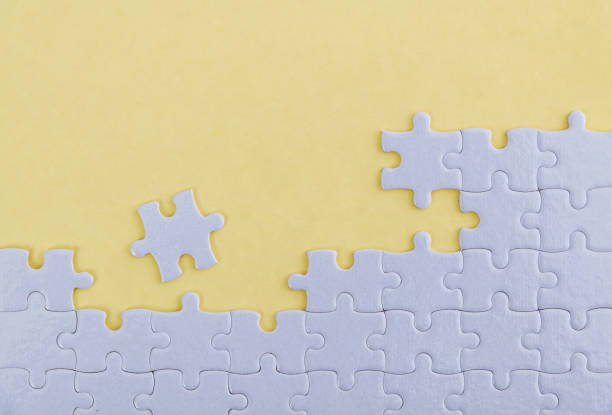 istock White jigsaw puzzle on yellow background 1193925632