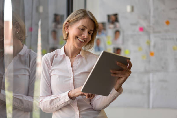 istock Senior business woman using app on a tablet computer 1193927196