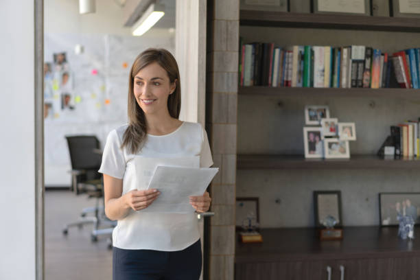 istock Thoughtful business woman holding documents at the office 1193927208