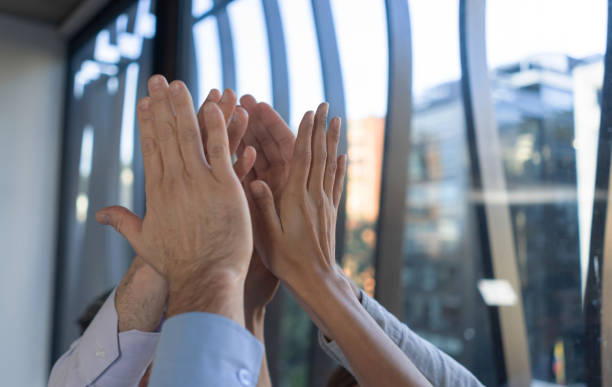 istock Close-up on a business group giving a high-five 1193927215