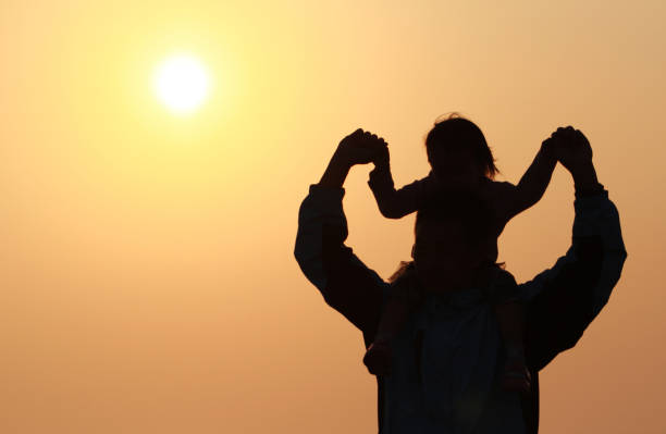 istock silhouette of father and daughter 1193928039