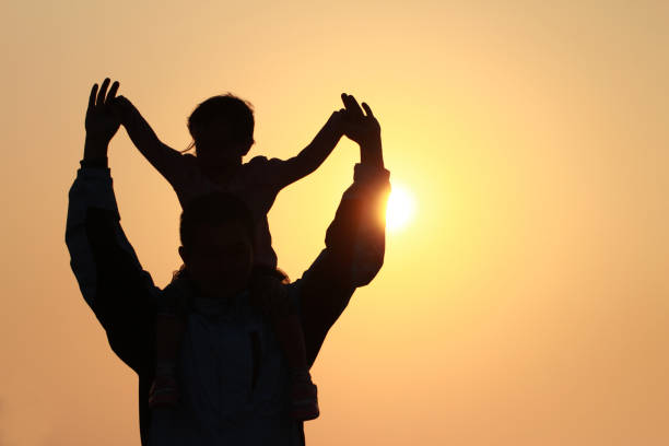 istock silhouette of father and daughter 1193928090