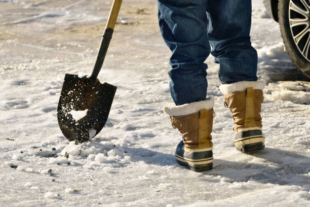 istock Man Chopping Ice in the Driveway 1193928113