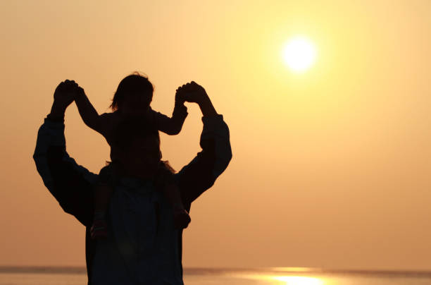istock silhouette of father and daughter 1193928131