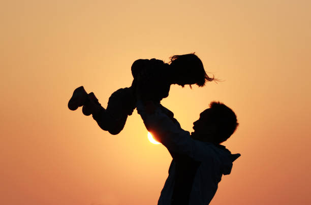 istock silhouette of father and daughter 1193928398
