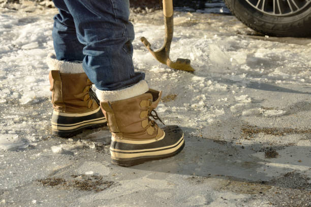 Man Chopping Ice in the Driveway