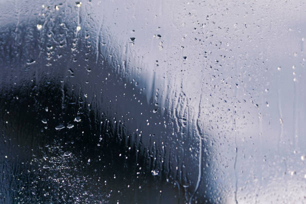 istock Window glass with drops and silhouettes 1193931586