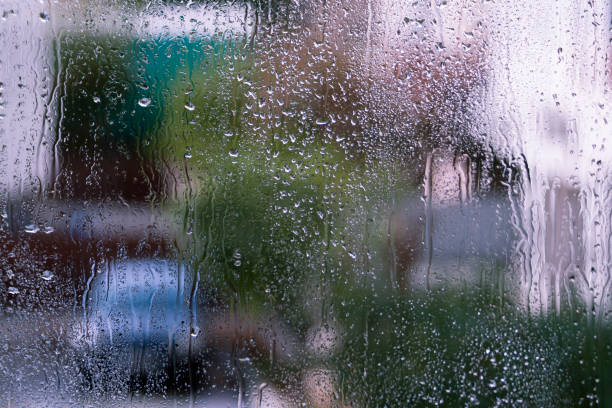 istock Wet window glass with street view 1193931591