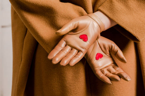 gloves with red hearts in the palm - camel back imagens e fotografias de stock