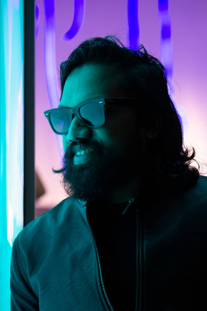 istock Man with sunglasses in front of a neon background 1193933250