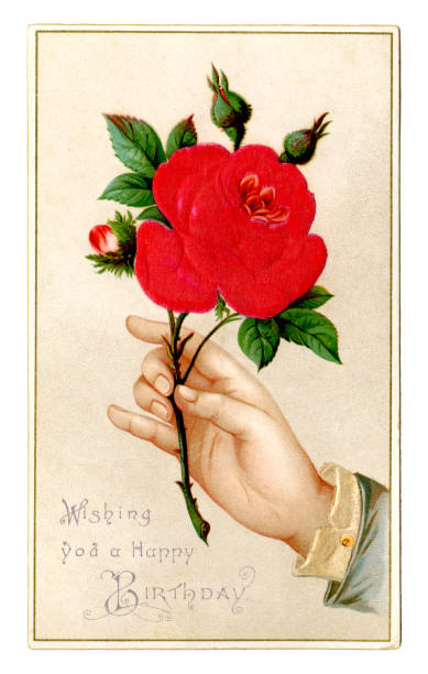 A Victorian birthday card with an embossed illustration of a large bright red rose being held by a rather small hand and the message “Wishing you a Happy Birthday”.