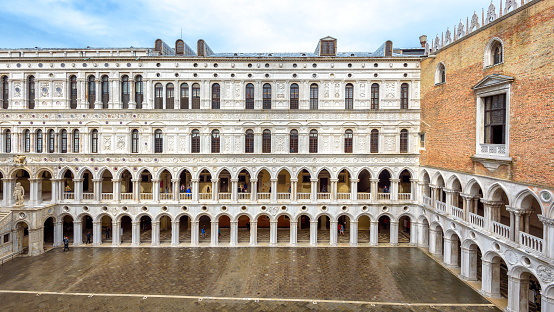 Venice, Italy - May 20, 2017: Doge`s Palace or Palazzo Ducale, Venice, Italy. It is a famous landmark of Venice. Panoramic view of courtyard of old Doge`s house with nice colonnade. Nice Renaissance architecture of Venice.