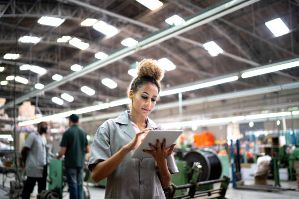 Woman using digital tablet in the industry