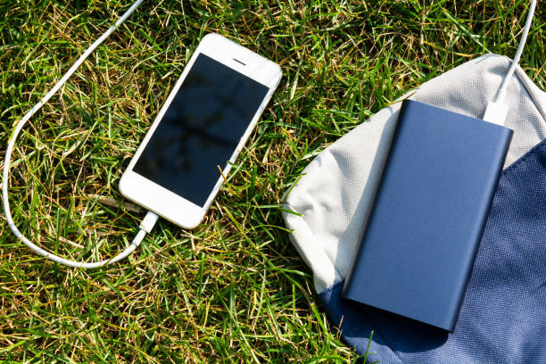 istock power Bank and phone on the grass 1193936303