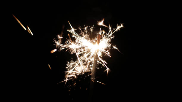 istock Close-up of firework sparkler burning. Fireworks burn on a black background 1193939457