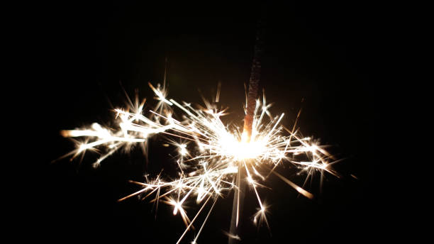 istock Close-up of firework sparkler burning. Fireworks burn on a black background 1193939856