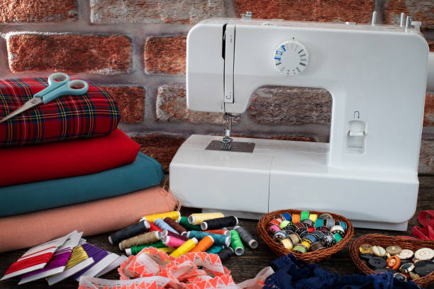 istock Many colorful threads and a sewing machine on the table 1193944079
