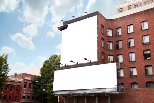 Dos vallas publicitarias en edificio de ladrillos photo