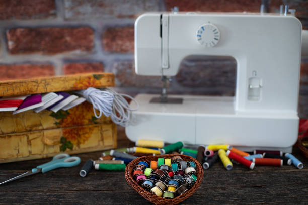 istock Many colorful threads and a sewing machine on the table 1193945823