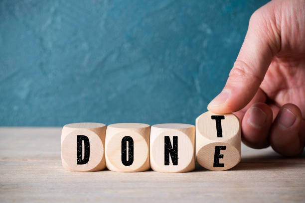 istock hand flips a cube with letters, changing the word 'don't' into 'done' 1193951380