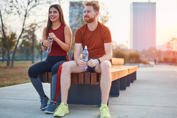 istock Modern couple making pause in an urban park during jogging / exercise. 1193952808