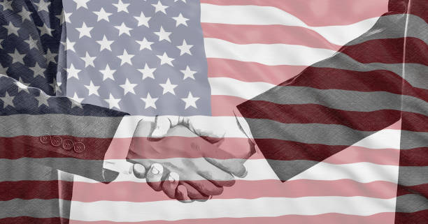 istock USA flag and men hands shaking background. 1193952954