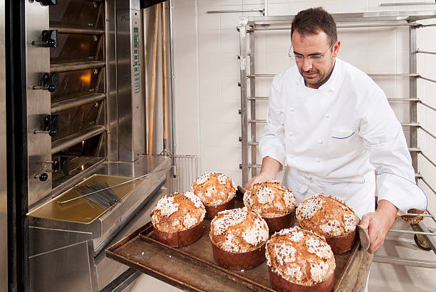istock Pastry chef putting some cakes in the oven 119395489