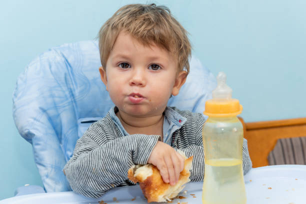A one-year-old boy eats Traditional Serbian cheese pie gibanica alone