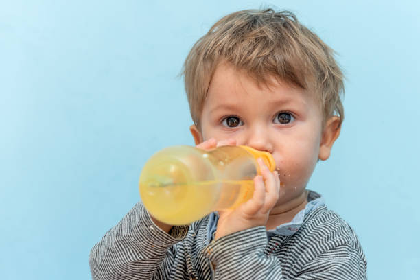 istock A one-year-old boy drinking water from a baby bottle 1193955115