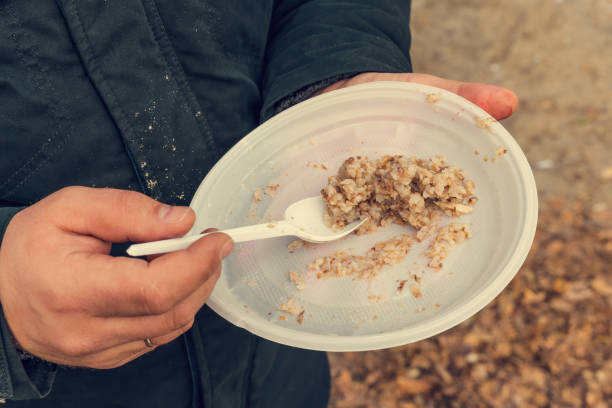 istock poor eat buckwheat gruel from disposable tableware 1193956040