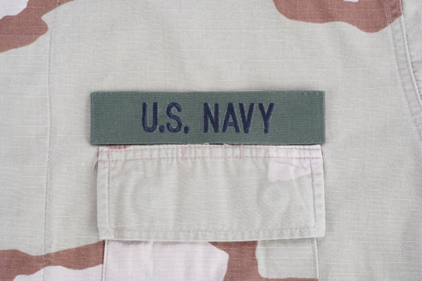 istock US NAVY branch tape on desert camouflage uniform background 1193956052