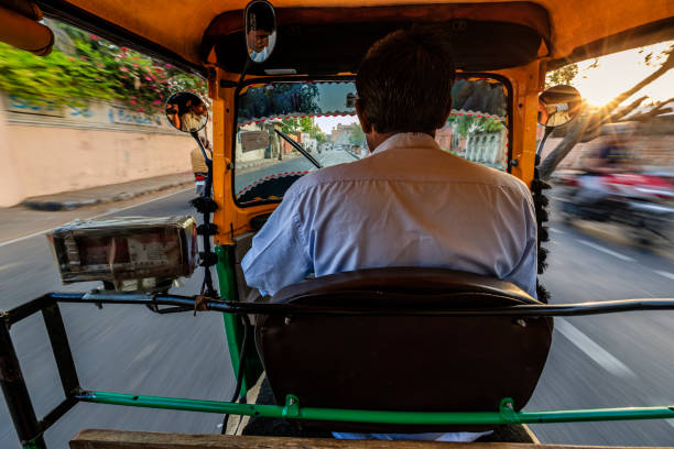 indian man drives auto rickshaw (tuk-tuk), india - jinrikisha imagens e fotografias de stock